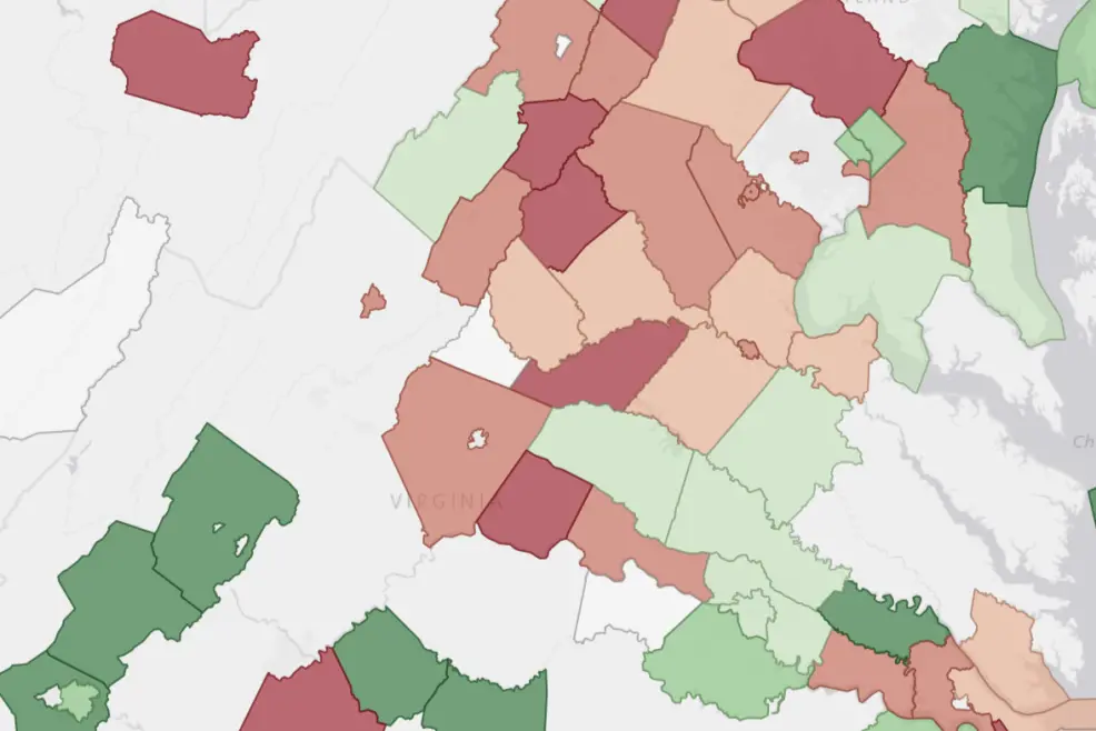 Screenshot of the data center community sentiment layer in PVcase Prospect over a map of Virginia and Maryland, showing the sentiment of each county towards data center in different tones of green (in favor) and red (against).